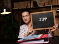 Business woman holding chalkboard with written text SafeÃÂ Interval Path Planning SIPP - closeup shot